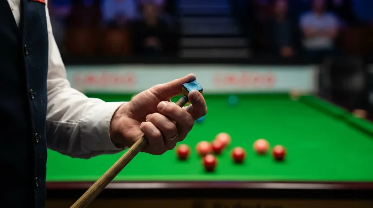 Snooker player competing under spotlight at a professional ranking event first round